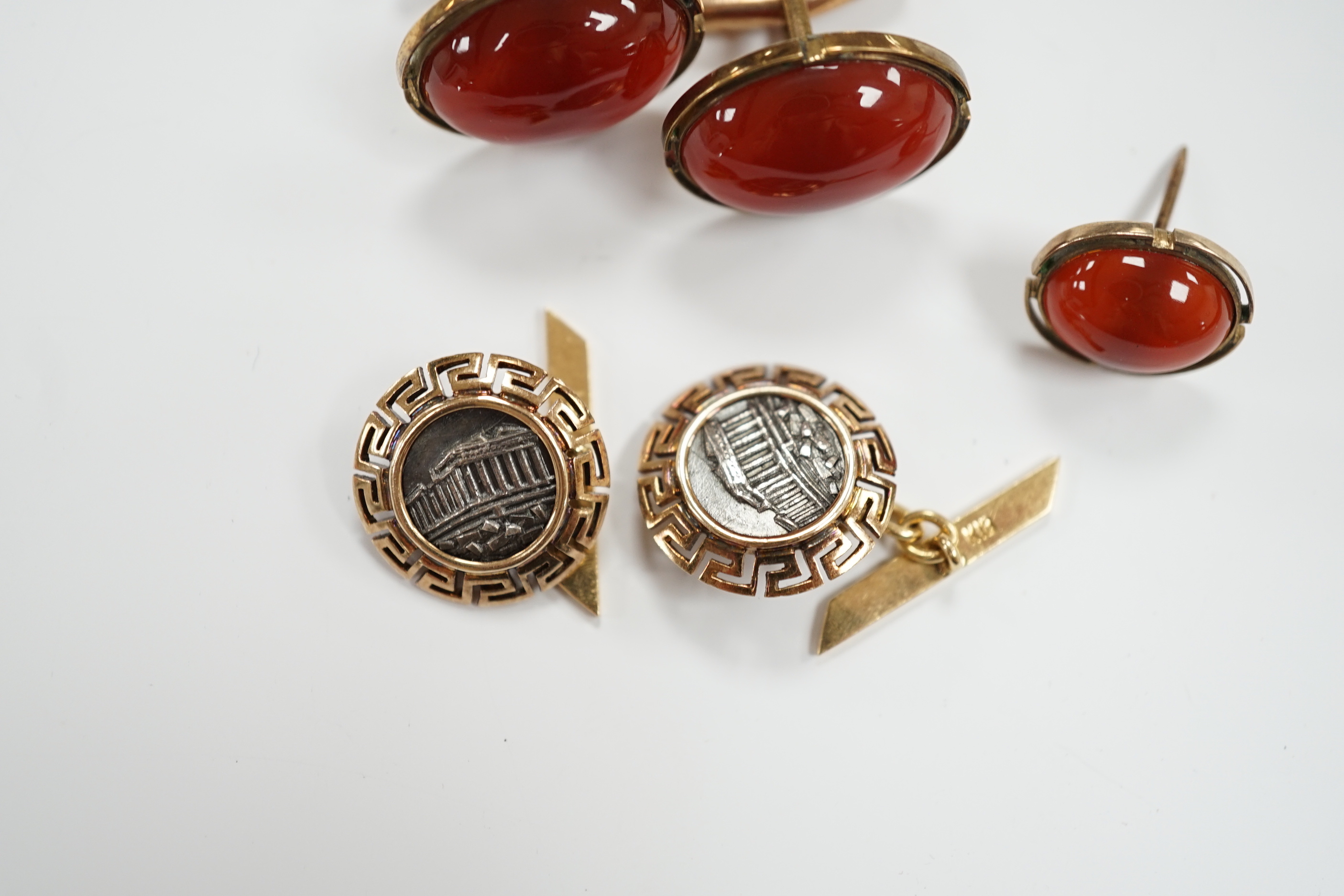 A pair of 18k and white metal 'Parthenon' circular cufflinks, with Greek Key border, 17mm, gross 8.9 grams, a pair of 10k and cabochon cufflinks and an earring.